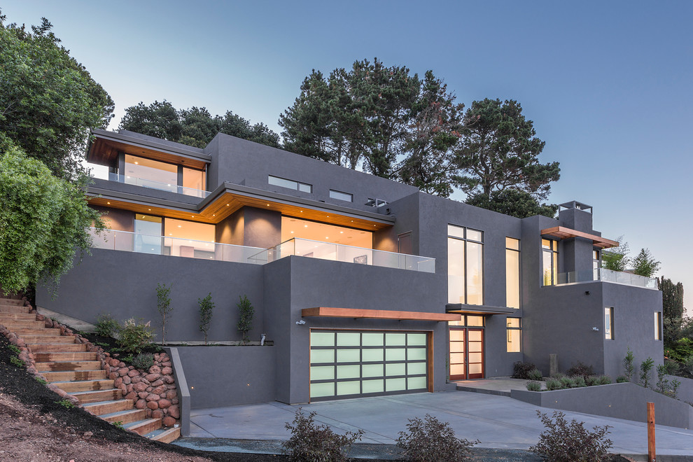 Contemporary three-storey grey house exterior in Sacramento with a flat roof.