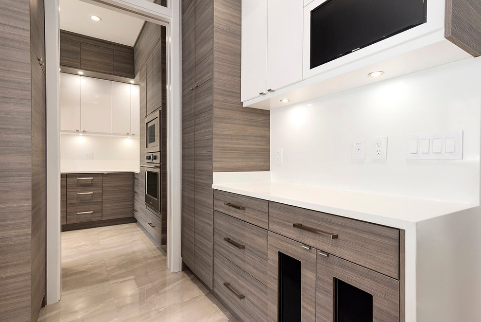 Photo of a large contemporary u-shaped open plan kitchen in Vancouver with an undermount sink, flat-panel cabinets, grey cabinets, quartzite benchtops, white splashback, stainless steel appliances, porcelain floors, with island, grey floor and white benchtop.