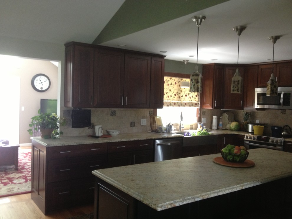 Example of a mid-sized eclectic l-shaped medium tone wood floor eat-in kitchen design in Bridgeport with an undermount sink, shaker cabinets, dark wood cabinets, granite countertops, beige backsplash, ceramic backsplash, stainless steel appliances and an island