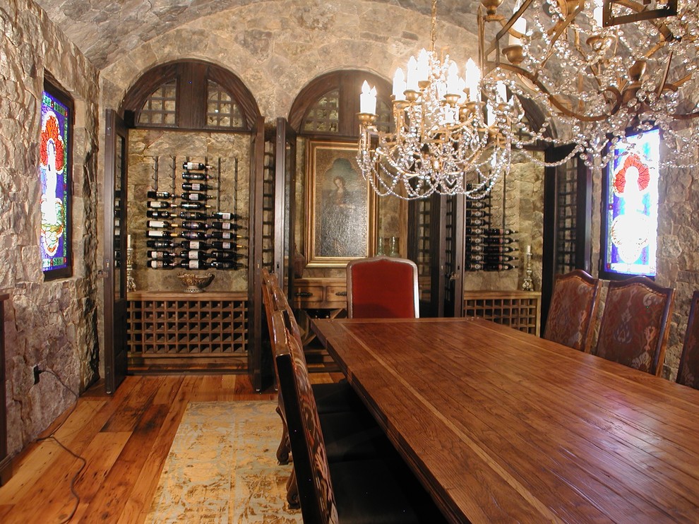 Inspiration for a traditional wine cellar in Denver with medium hardwood floors and display racks.