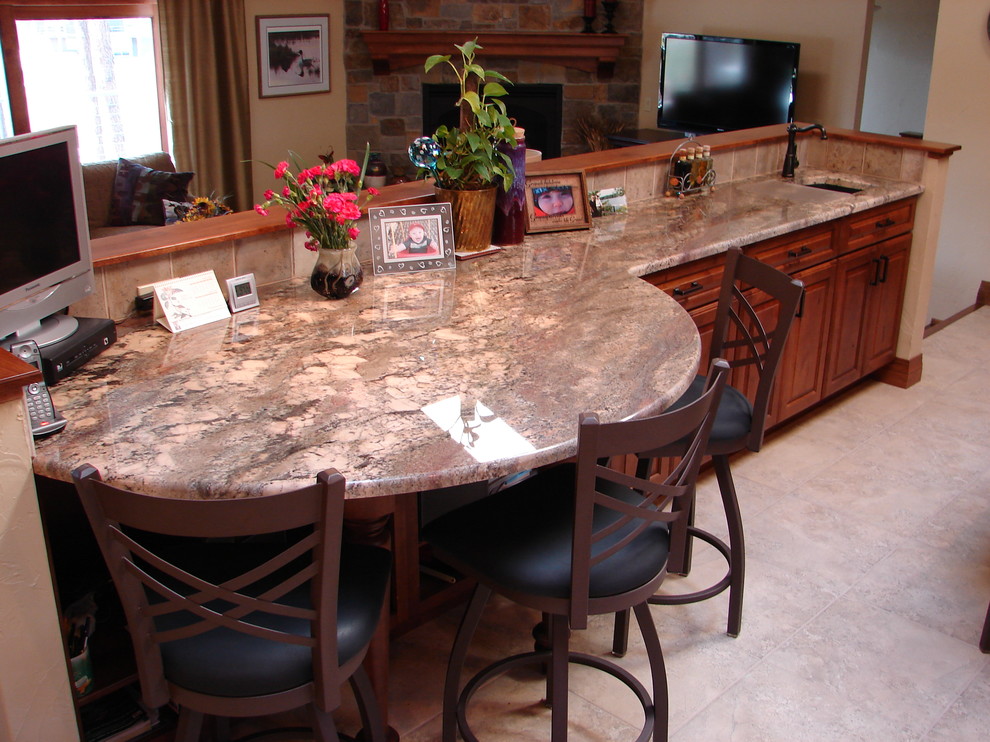 Transitional l-shaped eat-in kitchen photo in Denver with raised-panel cabinets, medium tone wood cabinets, granite countertops, beige backsplash, porcelain backsplash and stainless steel appliances