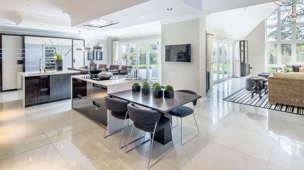 This is an example of a contemporary open plan kitchen in Berkshire with flat-panel cabinets, multiple islands, porcelain floors and an undermount sink.