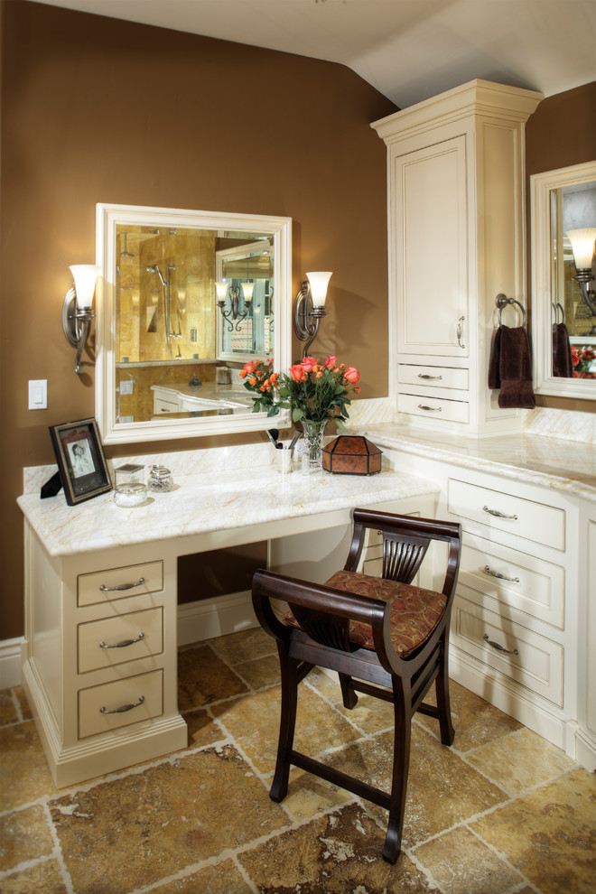 This is an example of a large traditional master bathroom in Sacramento with recessed-panel cabinets, white cabinets, marble benchtops, multi-coloured tile, stone tile, an undermount tub, an alcove shower, a one-piece toilet, an undermount sink, brown walls and limestone floors.