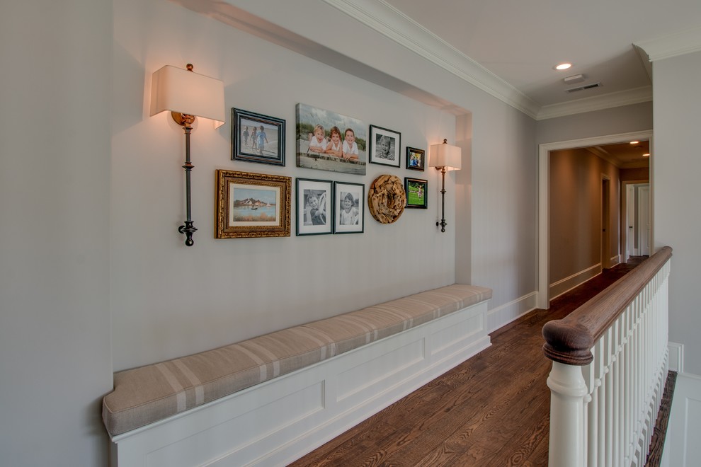 This is an example of a large contemporary hallway in Charlotte with grey walls, dark hardwood floors and brown floor.