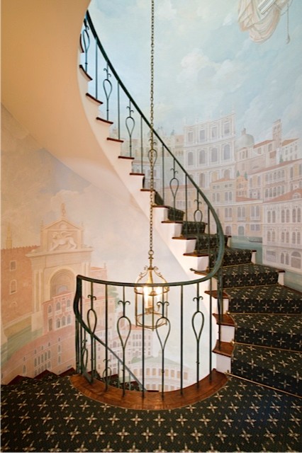 Inspiration for a large mediterranean carpeted spiral staircase in New York with wood risers.