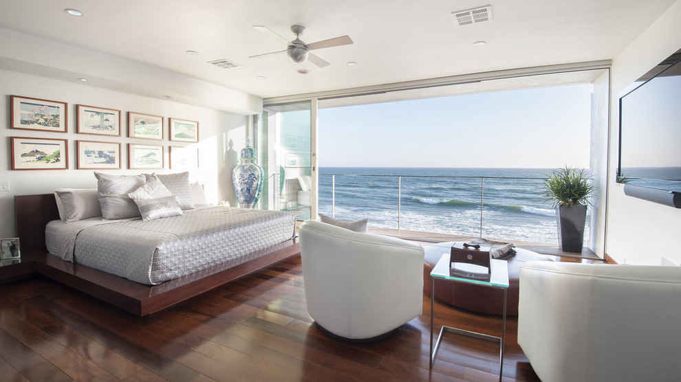 Inspiration for a beach style master bedroom in Los Angeles with white walls, no fireplace and dark hardwood floors.
