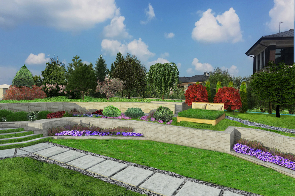 Large modern sloped full sun formal garden in Moscow with a retaining wall and river rock for summer.