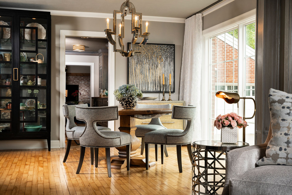 This is an example of a mid-sized transitional open plan dining in Other with light hardwood floors.
