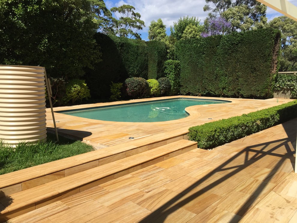 This is an example of a mid-sized mediterranean backyard custom-shaped lap pool in Sydney.