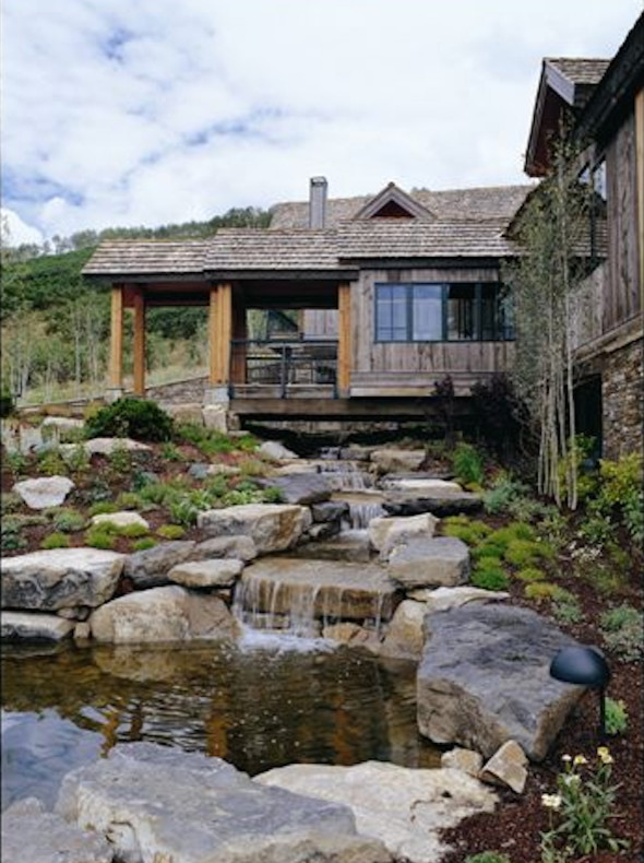 This is an example of a huge rustic drought-tolerant and full sun backyard stone water fountain landscape in Denver.
