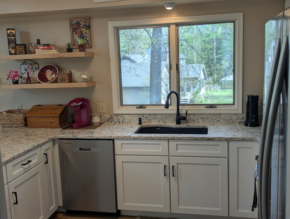 Small transitional u-shaped eat-in kitchen photo with flat-panel cabinets