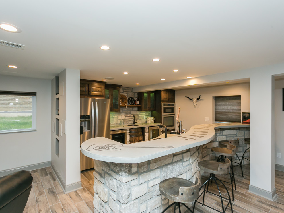 Photo of a country home bar in St Louis with concrete benchtops, stone tile splashback and grey benchtop.