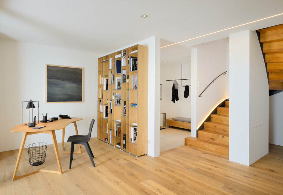This is an example of a mid-sized contemporary hallway in Other with white walls and medium hardwood floors.