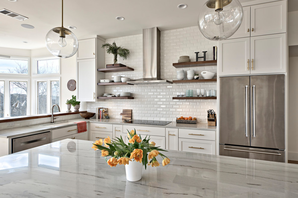 Design ideas for a country u-shaped open plan kitchen in Austin with shaker cabinets, marble benchtops, white splashback, subway tile splashback, medium hardwood floors and with island.