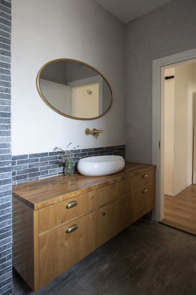 Photo of a mid-sized transitional master bathroom in Chicago with flat-panel cabinets, medium wood cabinets, a corner shower, a one-piece toilet, blue tile, ceramic tile, dark hardwood floors, a vessel sink, wood benchtops, brown floor, a hinged shower door, brown benchtops, a single vanity and a floating vanity.