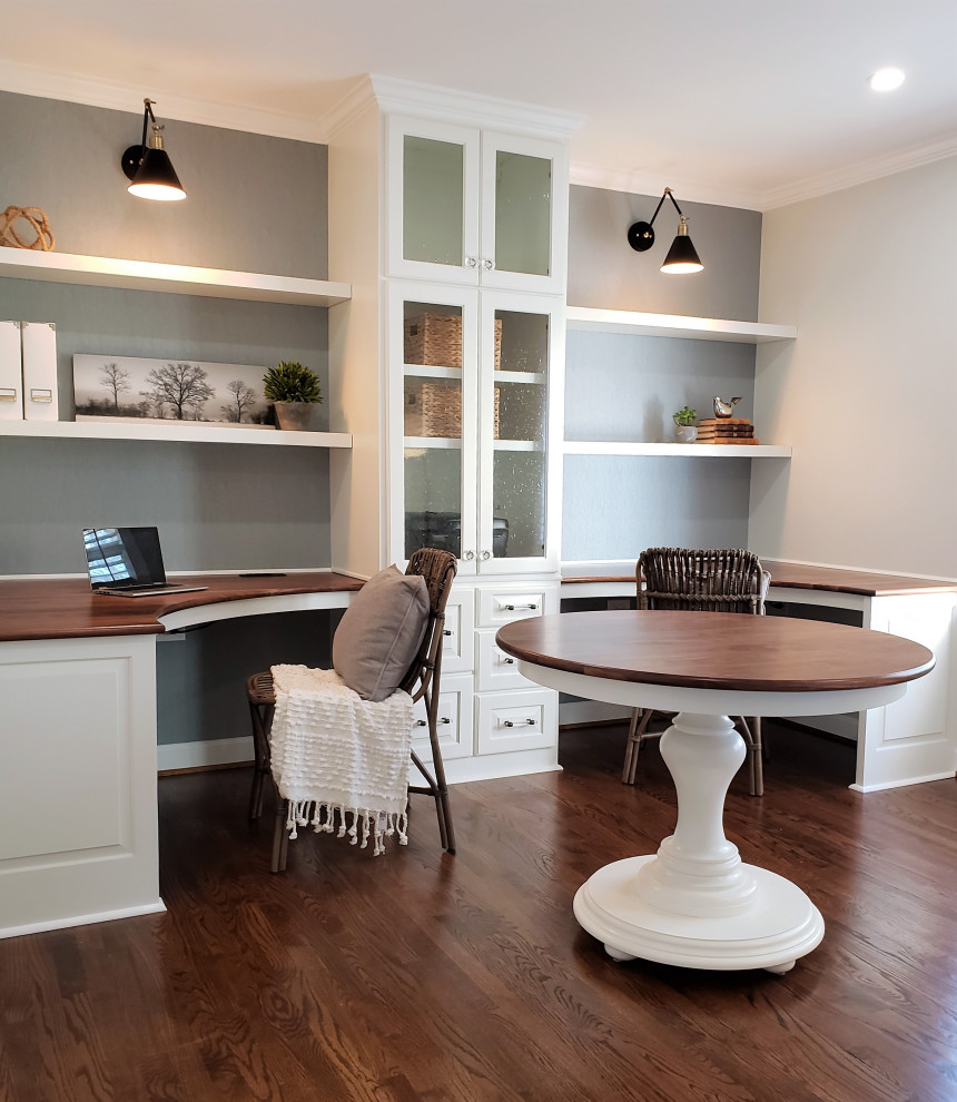 Design ideas for a mid-sized transitional study room in Atlanta with white walls, medium hardwood floors, a built-in desk and brown floor.