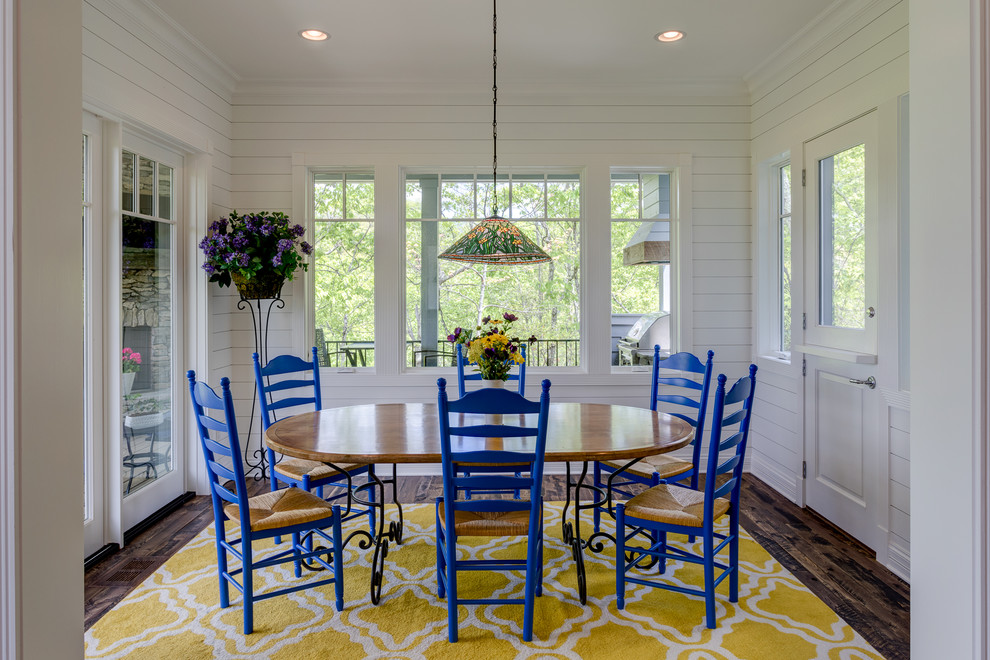 Inspiration for a cottage dark wood floor and brown floor enclosed dining room remodel in Other with white walls and no fireplace
