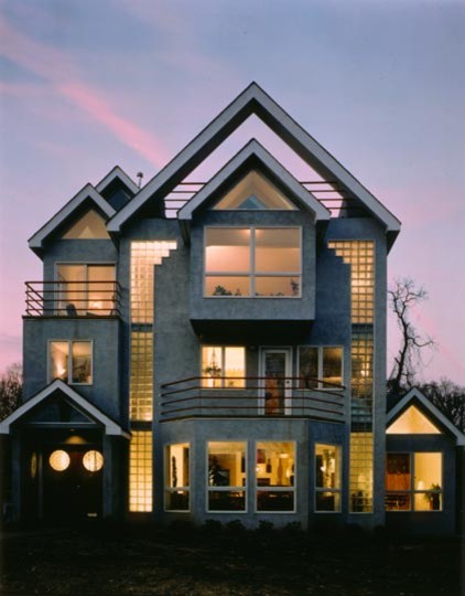 This is an example of a large modern three-storey concrete grey exterior in Dallas with a gable roof.