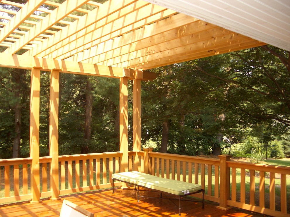 Design ideas for a mid-sized traditional backyard deck in New York with a pergola.