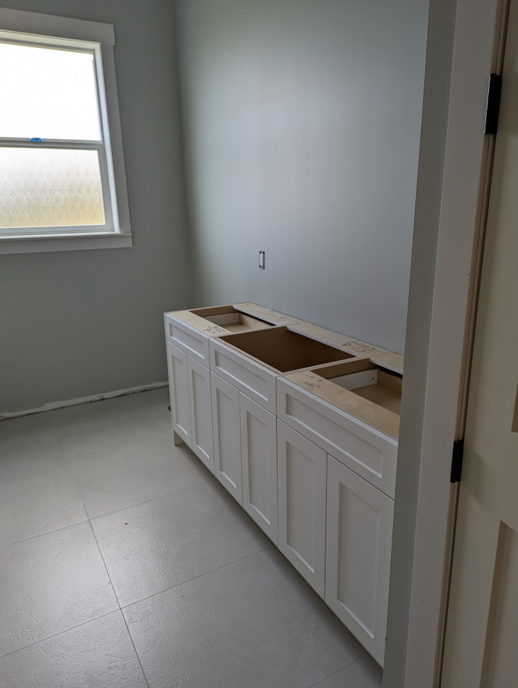White double sink vanity cabinet installation in bathroom remodel