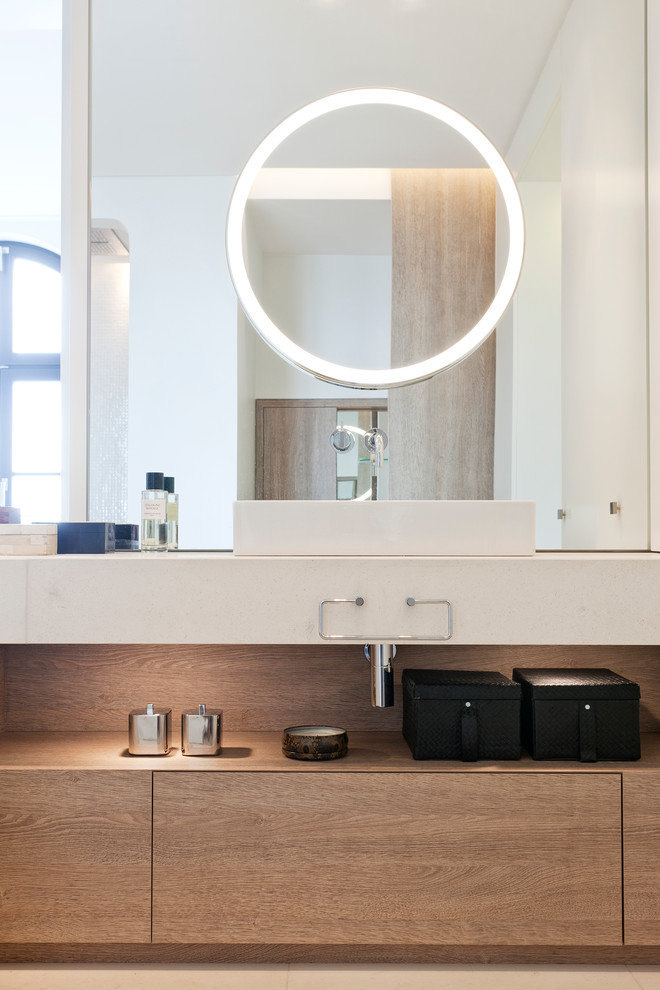 Mittelgroßes Modernes Badezimmer mit flächenbündigen Schrankfronten, weißen Schränken, freistehender Badewanne, beigen Fliesen, Steinplatten, weißer Wandfarbe, Kalkstein und Aufsatzwaschbecken in Berlin