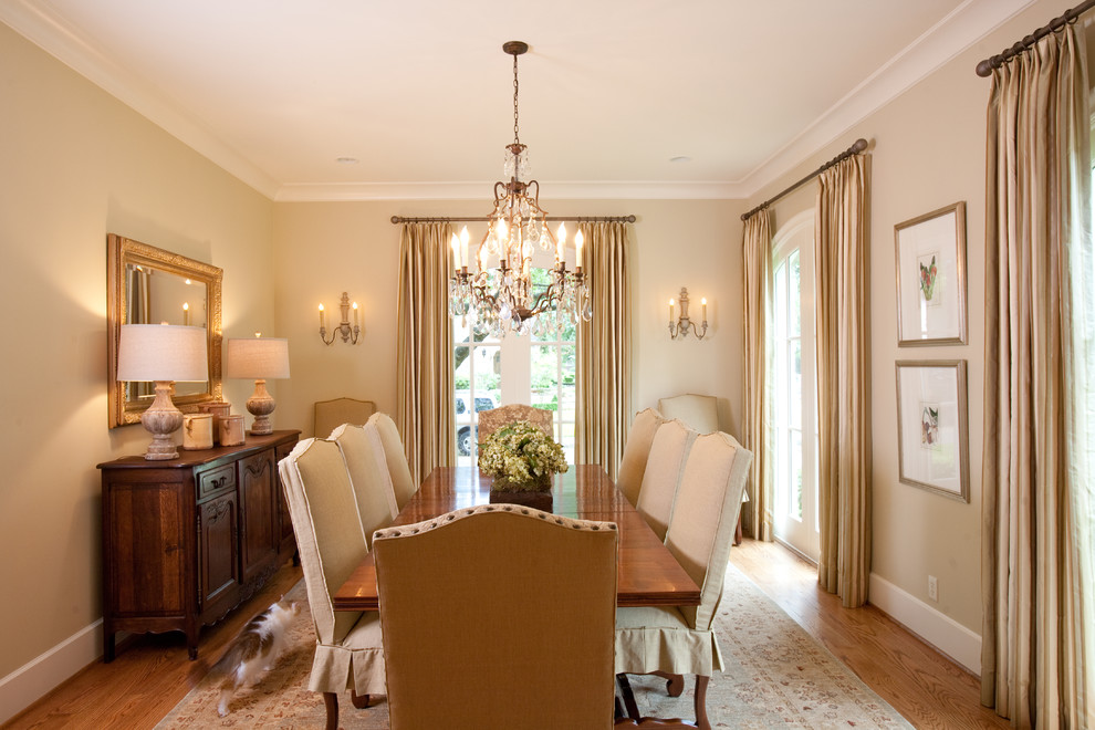 Photo of a large separate dining room in Houston with beige walls and light hardwood floors.