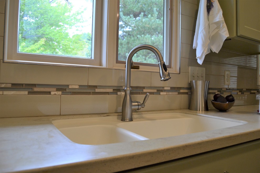 Inspiration for a mid-sized transitional l-shaped eat-in kitchen remodel with a double-bowl sink, shaker cabinets, green cabinets, white backsplash, subway tile backsplash and no island