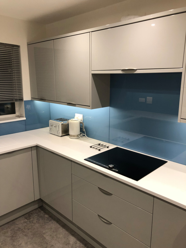 This is an example of a small modern galley eat-in kitchen in Other with an undermount sink, flat-panel cabinets, grey cabinets, quartzite benchtops, blue splashback, engineered quartz splashback, ceramic floors, no island, grey floor and white benchtop.