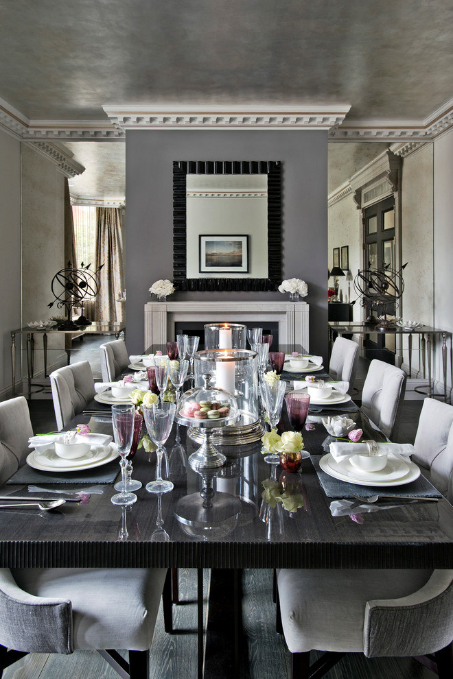 Inspiration for a transitional dining room in London with grey walls and dark hardwood floors.