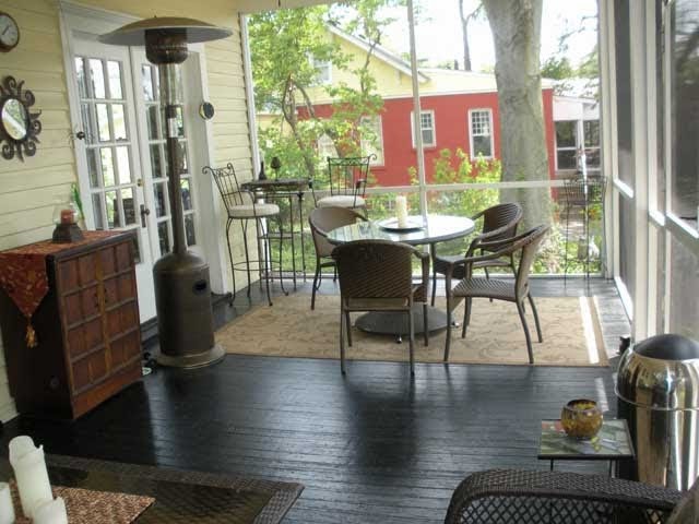 Large eclectic side yard patio in Louisville with decking and a roof extension.