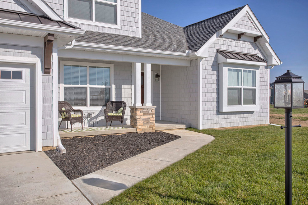 Example of a mid-sized transitional gray two-story vinyl exterior home design in Chicago with a hip roof