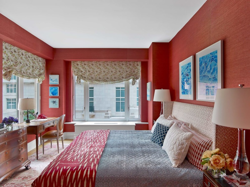 Inspiration for a mid-sized traditional bedroom in London with red walls.