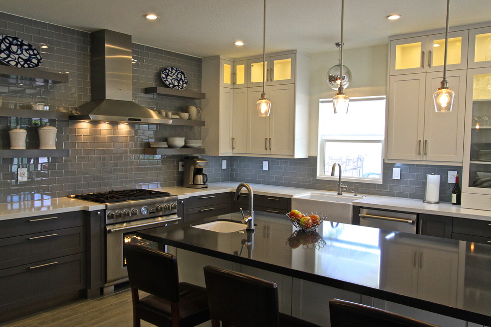 Transitional porcelain tile kitchen photo in Orange County with glass tile backsplash and an island