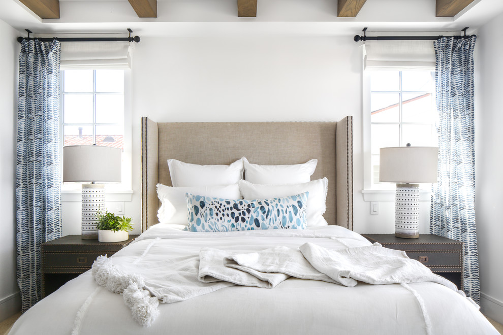 This is an example of a beach style bedroom in Los Angeles with white walls.