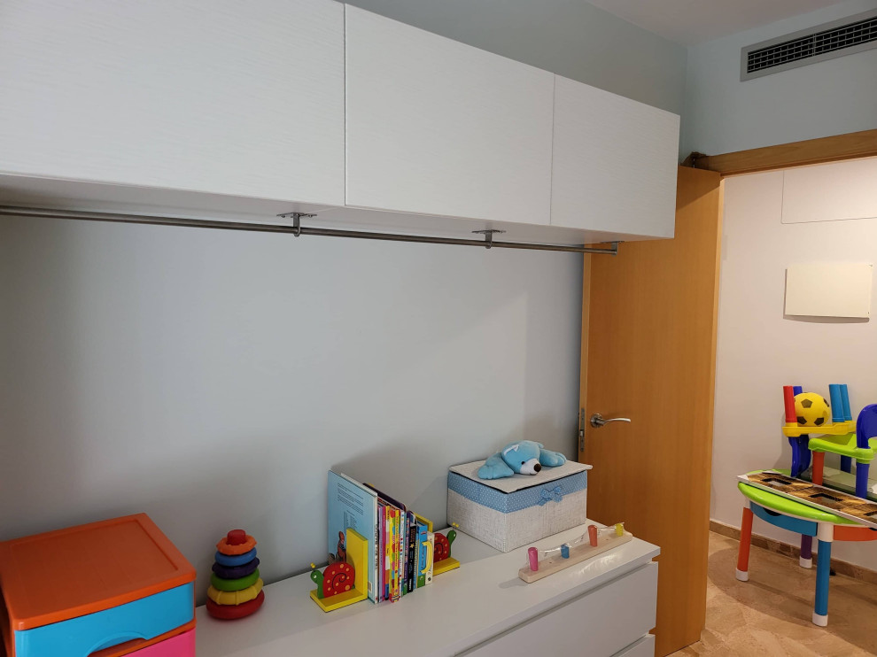 This is an example of a mid-sized transitional kids' room in Other.