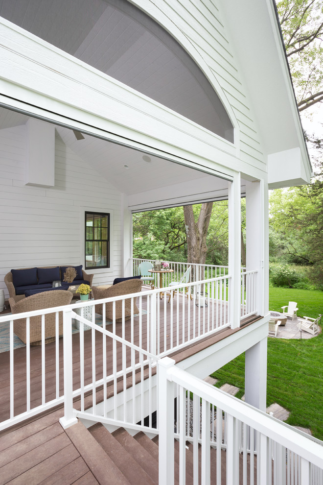 Deck - large transitional backyard deck idea in Minneapolis with a roof extension
