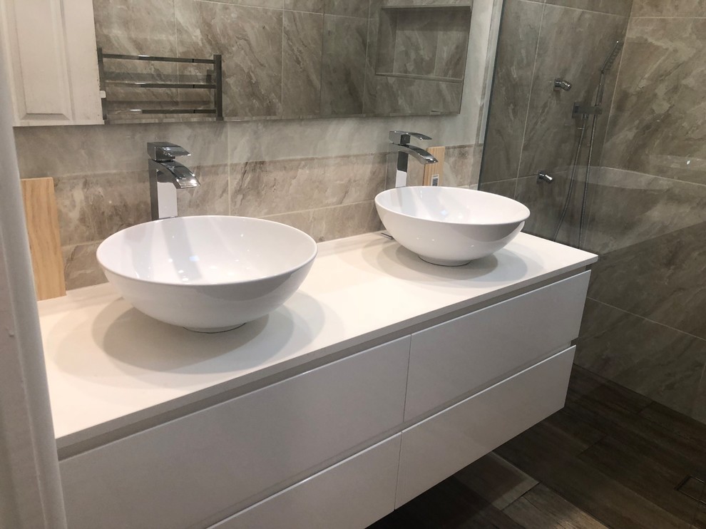 This is an example of a mid-sized modern master bathroom in Melbourne with an open shower, brown tile, ceramic tile, ceramic floors and brown floor.