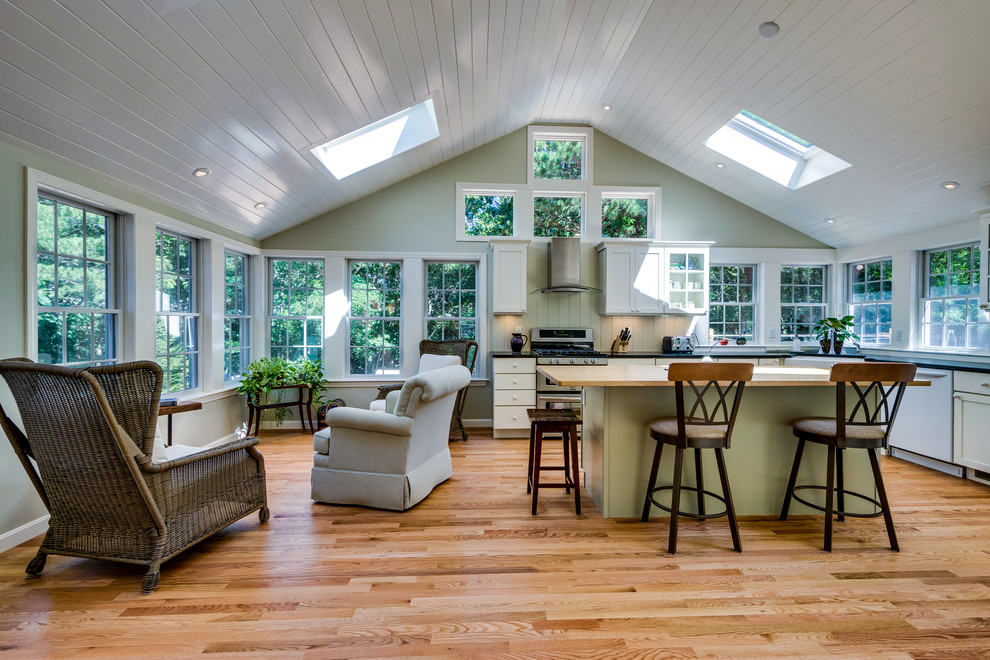 Eat-in kitchen - large transitional l-shaped light wood floor eat-in kitchen idea in Boston with a farmhouse sink, shaker cabinets, white cabinets, quartzite countertops, stainless steel appliances and an island