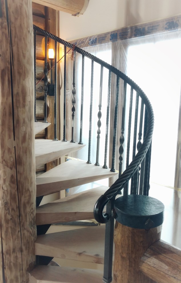 Example of a mid-sized mountain style spiral metal railing staircase design in Denver