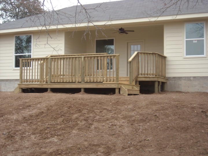 Backyard deck photo in Austin with no cover