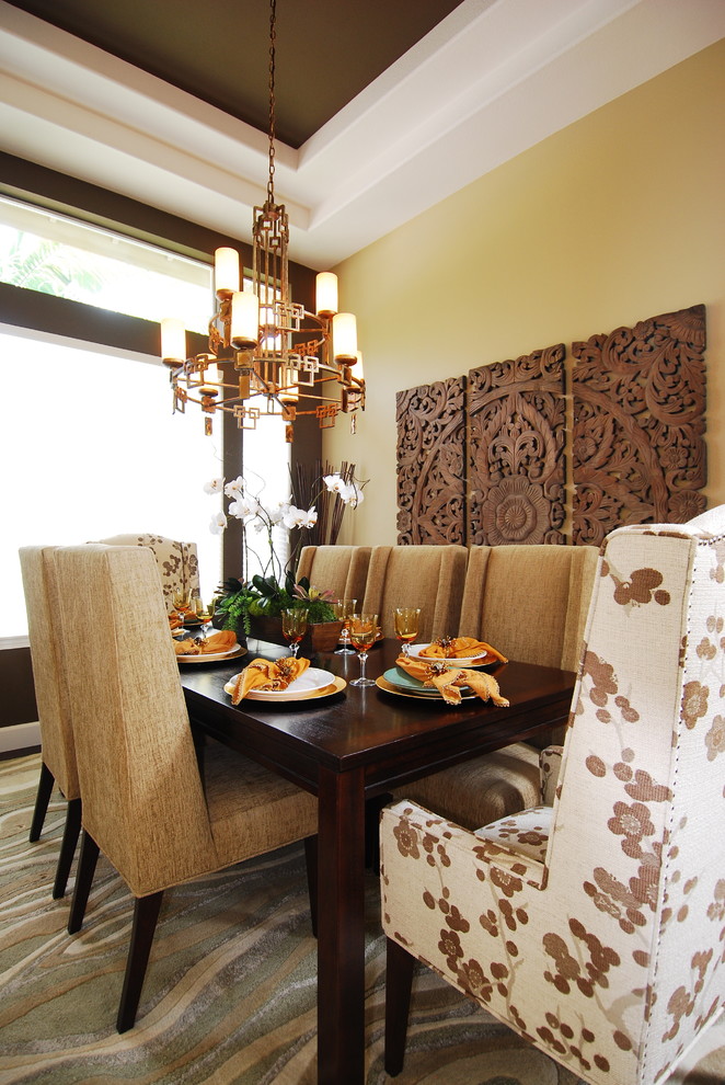 Design ideas for a transitional dining room in San Diego with yellow walls and carpet.