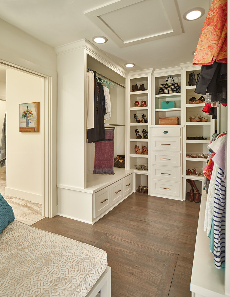 Design ideas for a transitional gender-neutral dressing room in Dallas with shaker cabinets, white cabinets, medium hardwood floors and brown floor.