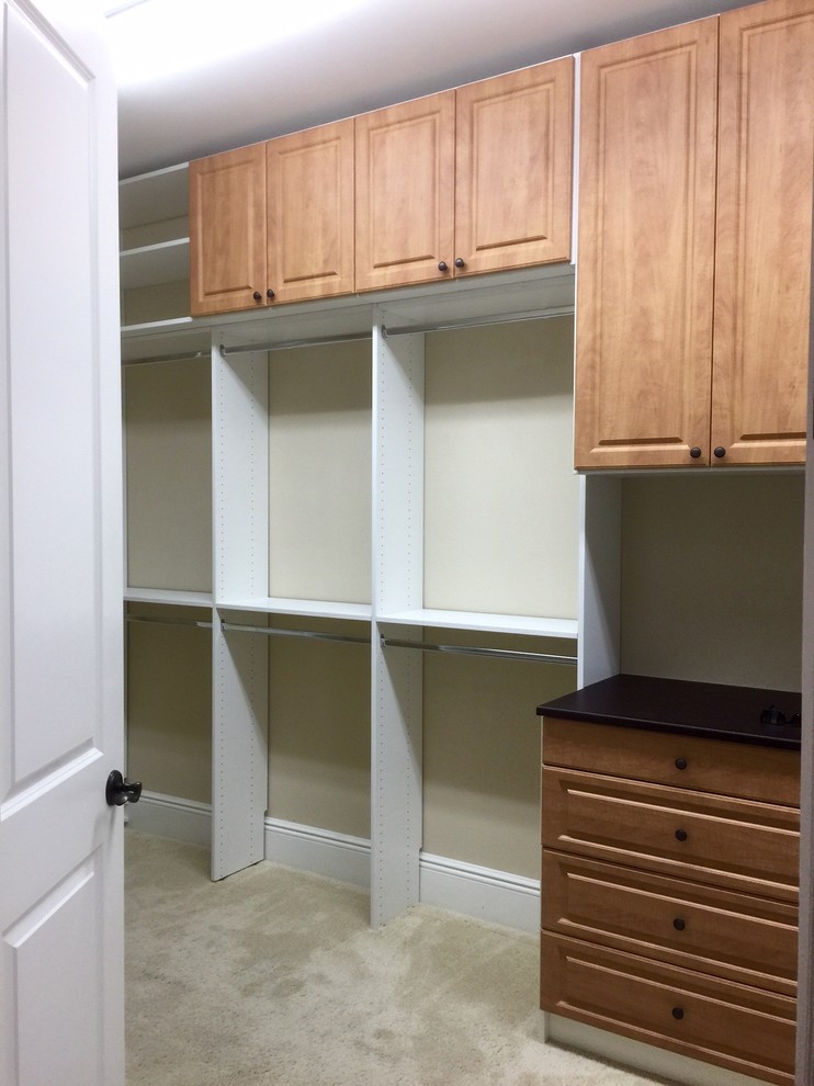 Inspiration for a large beach style men's walk-in wardrobe in New York with raised-panel cabinets, white cabinets and carpet.