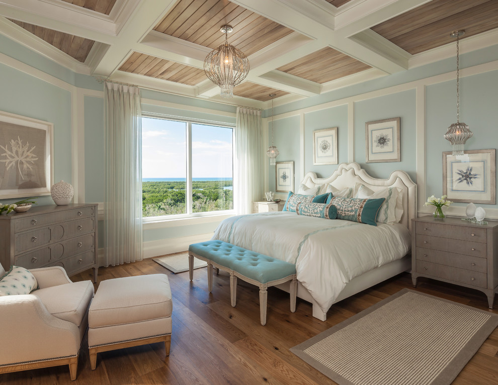 Design ideas for a large beach style master bedroom in Miami with blue walls and medium hardwood floors.