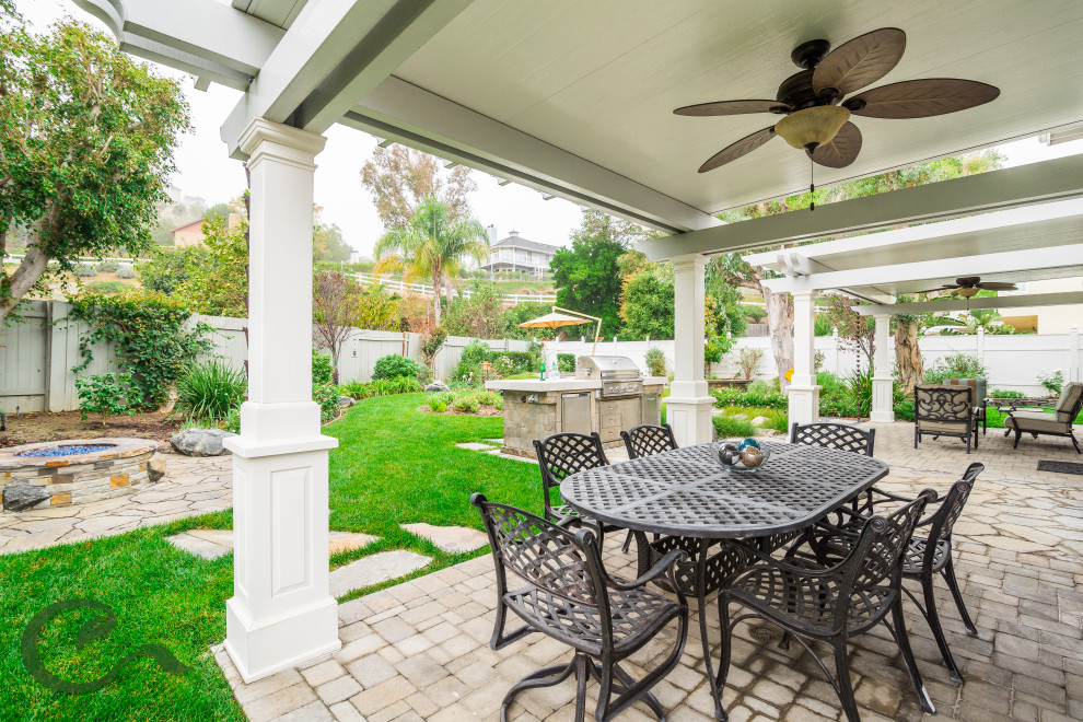 Photo of a mid-sized beach style backyard patio in Orange County with concrete pavers and a gazebo/cabana.