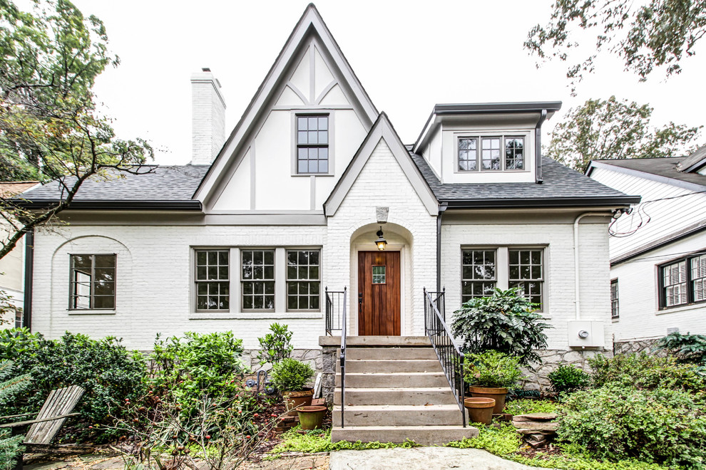 This is an example of a mid-sized traditional two-storey brick white exterior in Atlanta with a gable roof.
