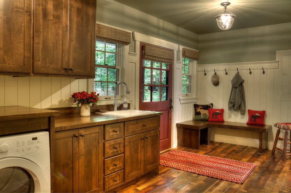 Inspiration for a country laundry room in Minneapolis with a drop-in sink, medium hardwood floors and a side-by-side washer and dryer.