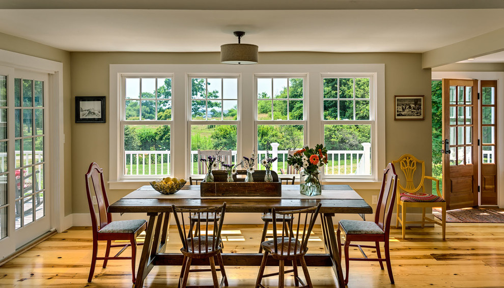 Mid-sized country kitchen/dining combo in Boston with beige walls and medium hardwood floors.