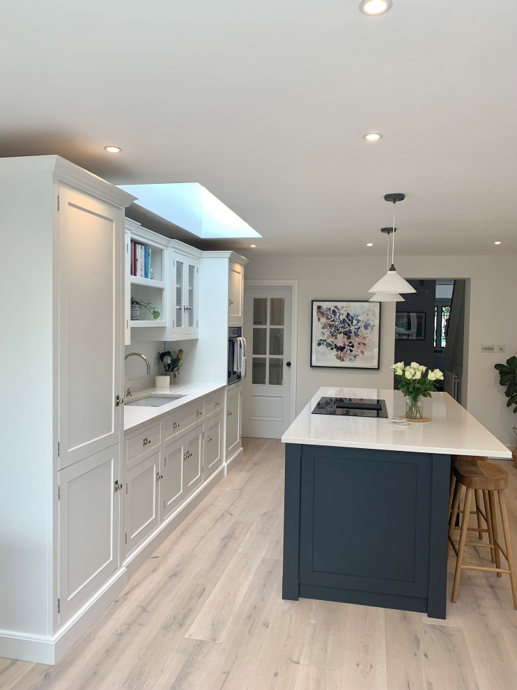 Inspiration for a modern open concept kitchen remodel in Surrey with an integrated sink, beaded inset cabinets, gray cabinets, an island and white countertops