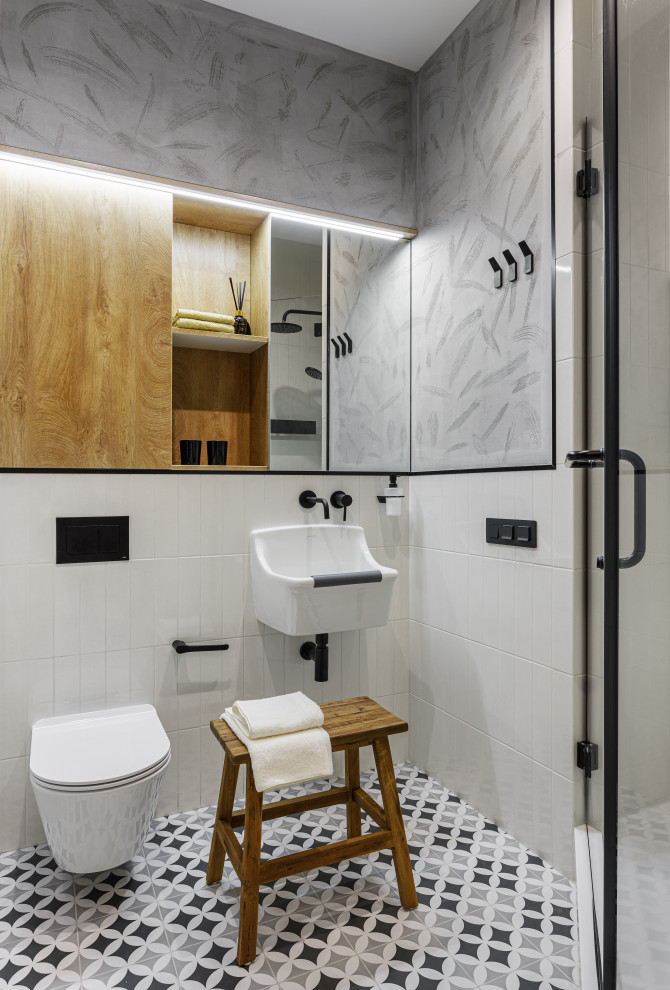 Small contemporary powder room in Moscow with flat-panel cabinets, medium wood cabinets, a wall-mount toilet, white tile, ceramic tile, grey walls, porcelain floors, a wall-mount sink, multi-coloured floor and a floating vanity.